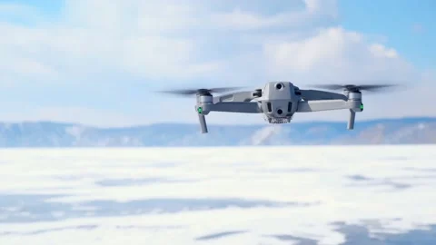 A man's hand catches a drone floating in the air in winter. close-up. 4K. Stock Footage 172585816