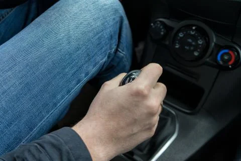 Man's Hand Changing Gear While Driving Stock Photos