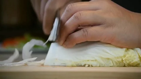 Man's hand chopping cabbage with knife in Kitchen Stock Footage 158834798