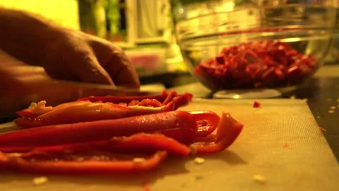 A man's hand is chopping capia pepper Stock Footage 141234624
