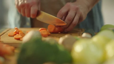 Man's hand chopping a carrot Stock Footage 311835190
