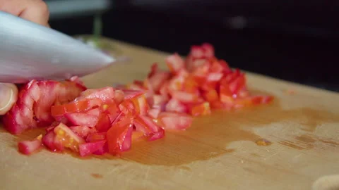 Man's hand chopping tomatoes Stock Footage 164867793