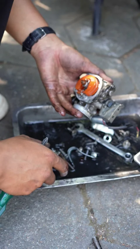 A man's hand cleaning a motorbike engine cylinder. mechanic's hands cleaning ser Stock Footage 286937982