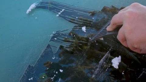 A mans hand clears the icy window of a car. Car care in winter. Stock Footage 317847472
