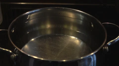 The man's hand close the lid at the pan with water. Stock Footage 147884641