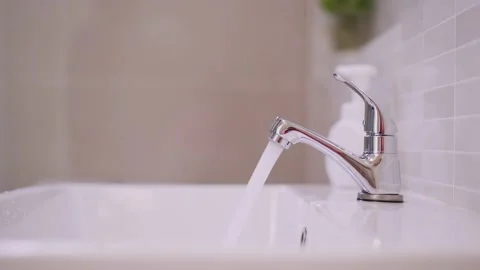 Man's hand closes the open water tap. Save energy, save water. Preserve natur Stock Footage 139053898