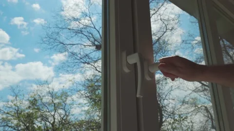 A man's hand closes the window. Stock Footage 192759423