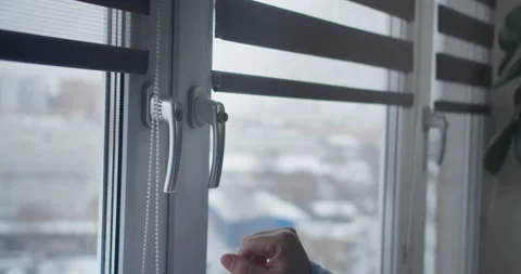 Man's hand closes the window with a lock on the button Stock Footage 148433328
