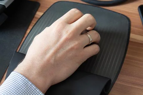 A man's hand on a computer mouse remote work Stock Photos