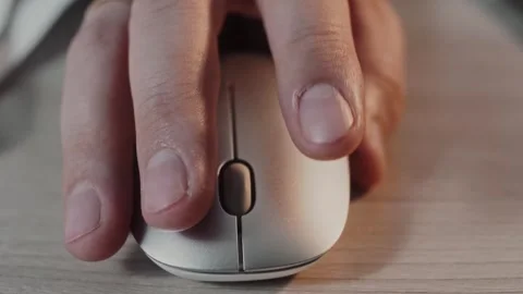 Man's hand on a computer mouse is spinning a wheel and pressing buttons Stock Footage 307598581