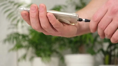 Man's hand connects magnetic cable for charging smartphone Stock Footage 243288776