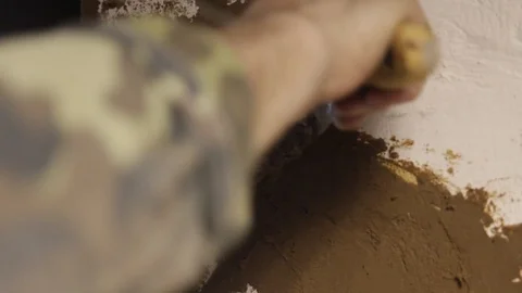 Man's hand covers wall with cement Stock Footage 122643893