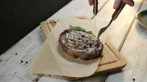 Man's hand cut steak meat dish Stock Footage 67747625