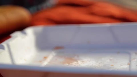 Man's hand cut tomato into thin pieces with plastic knife. Stock Footage 202119028