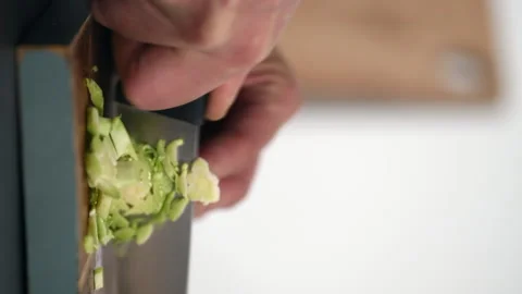 Man's Hand Cutting a Brussel Sprouts on a Wood Cutting Board Stock Footage 143916265