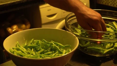 A man's hand cutting green beans on the table. Stock Footage 142041608
