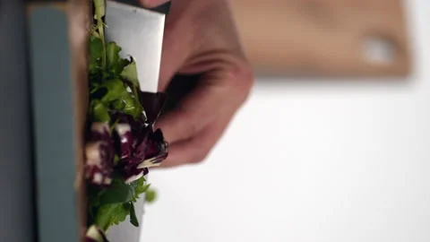 Man's Hand Cutting a Salad on a Wood Cutting Board Stock Footage