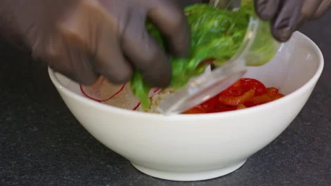 Man's hand decorates white rice with red pepper radish and seaweed. Stock Footage 158774943
