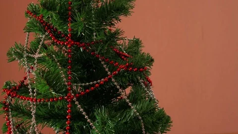 Mans hand decorating christmas tree Stock Footage 84152785