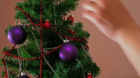 Mans hand decorating christmas tree Stock Footage 84153600