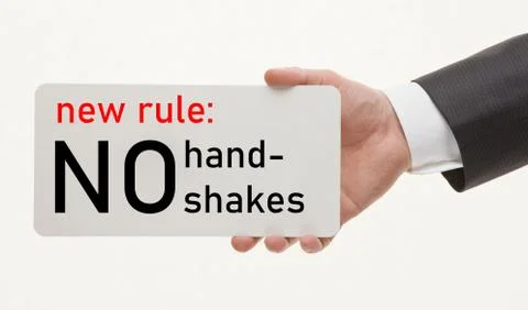 Man's hand demonstrates a reminder to avoid handshakes Stock Photos