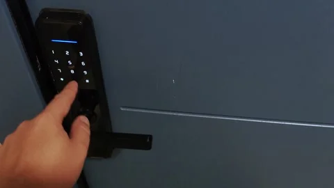 A man's hand dials the code of a modern electronic door lock, close-up Video stock 254669080
