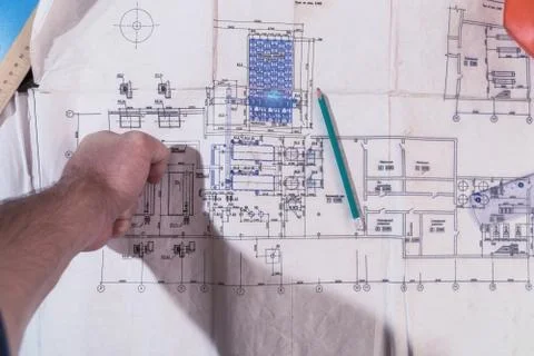 A man's hand draws a construction drawing Stock Photos