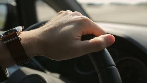 Man's hand is driving car at sunset Stock Footage 73998745