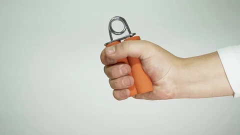 Man's hand is exercising with a handheld trainer Stock Footage 103428744