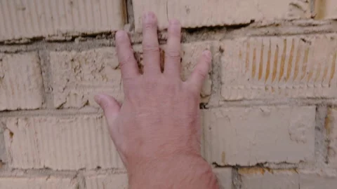 A man’s hand feels the brick wall. From the first person. 動画素材 342421885
