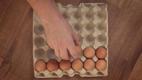 Man’s hand filling egg tray 스톡 동영상 87343371