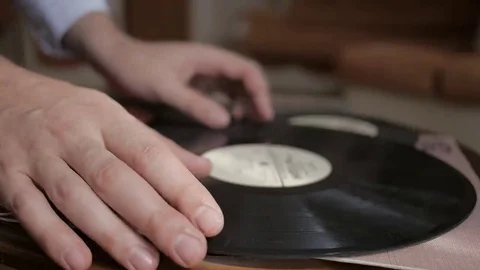 Man's hand, fingers gently touch retro vinyl record and take it. Close up. Stock Footage 69218938