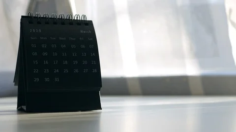 A Man's Hand Flips The Sheets Of A 2020 Year Black Mini Monthly Standing Desk Ca Video stock 123372100