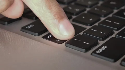Man's hand forefinger pressing enter key on modern laptop computer keyboard Vidéo 291855704