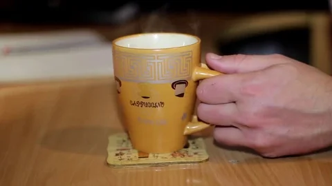 Man's Hand is in The Frame, Which Takes a Cup of Coffee at Home Stockbeeldmateriaal 69179965