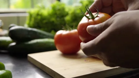 Man's hand going through fresh organic red tomatoes Stock Footage 272181848