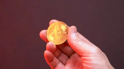 Man's hand with a gold bitcoin Stock Footage 289273465