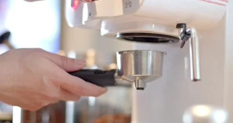 Man's hand grabs coffee Bottomless and puts it in the coffee machine. Stock Footage 223209567