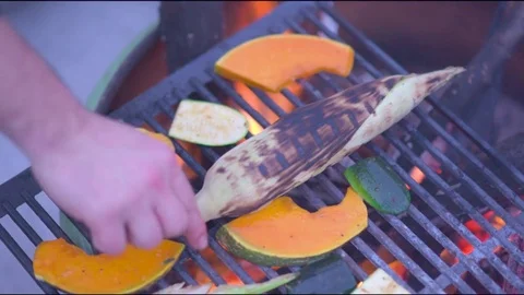 Man's hand grilling vegetables on barbecue grill Stock Footage 76101718