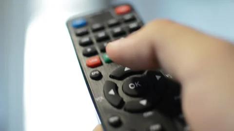 Man's hand hold television remote with thumb pressing button Video stock 201081303