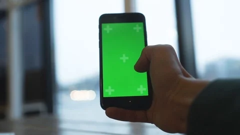 Mans hand hold use smartphone with green screen. Stock Footage 127462448