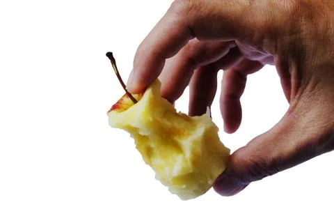 Man's hand holding an apple core with clipping path isolated on white backgro Stock Photos