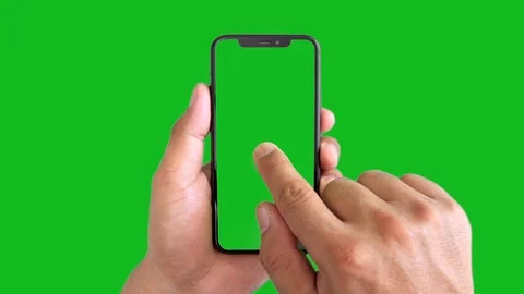 Man's hand holding a black smartphone with green screen and touching . Stock Footage