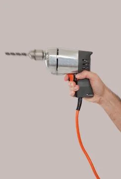Man's hand holding a drill Stock Photos