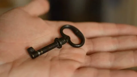 Man's hand holding old fashioned vintage key. antique key. Stock-Footage 218482329