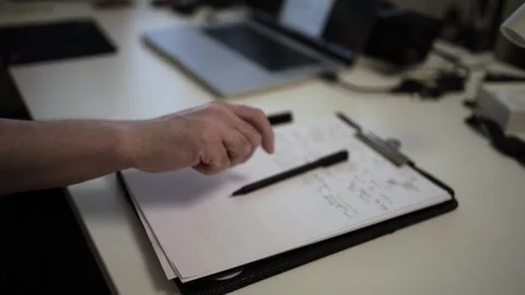 Mans Hand Holding a Pen While Writing on a Notebook. Journaling his thought.. Stock-Footage 306064710