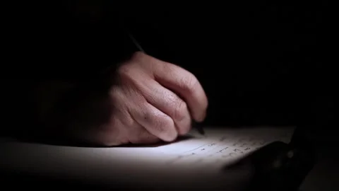 Mans Hand Holding a Pen While Writing on a Notebook. Journaling his thought.. Stock Footage 306065506
