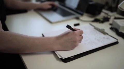 Mans Hand Holding a Pen While Writing on a Notebook. Journaling his thought.. Stock Footage 306065775