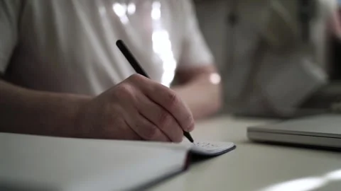 Mans Hand Holding a Pen While Writing on a Notebook. Journaling his thought.. Vídeos de archivo 306066131