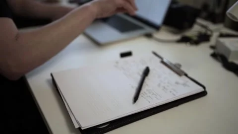 Mans Hand Holding a Pen While Writing on a Notebook. Journaling his thought.. Stock Footage 306067835